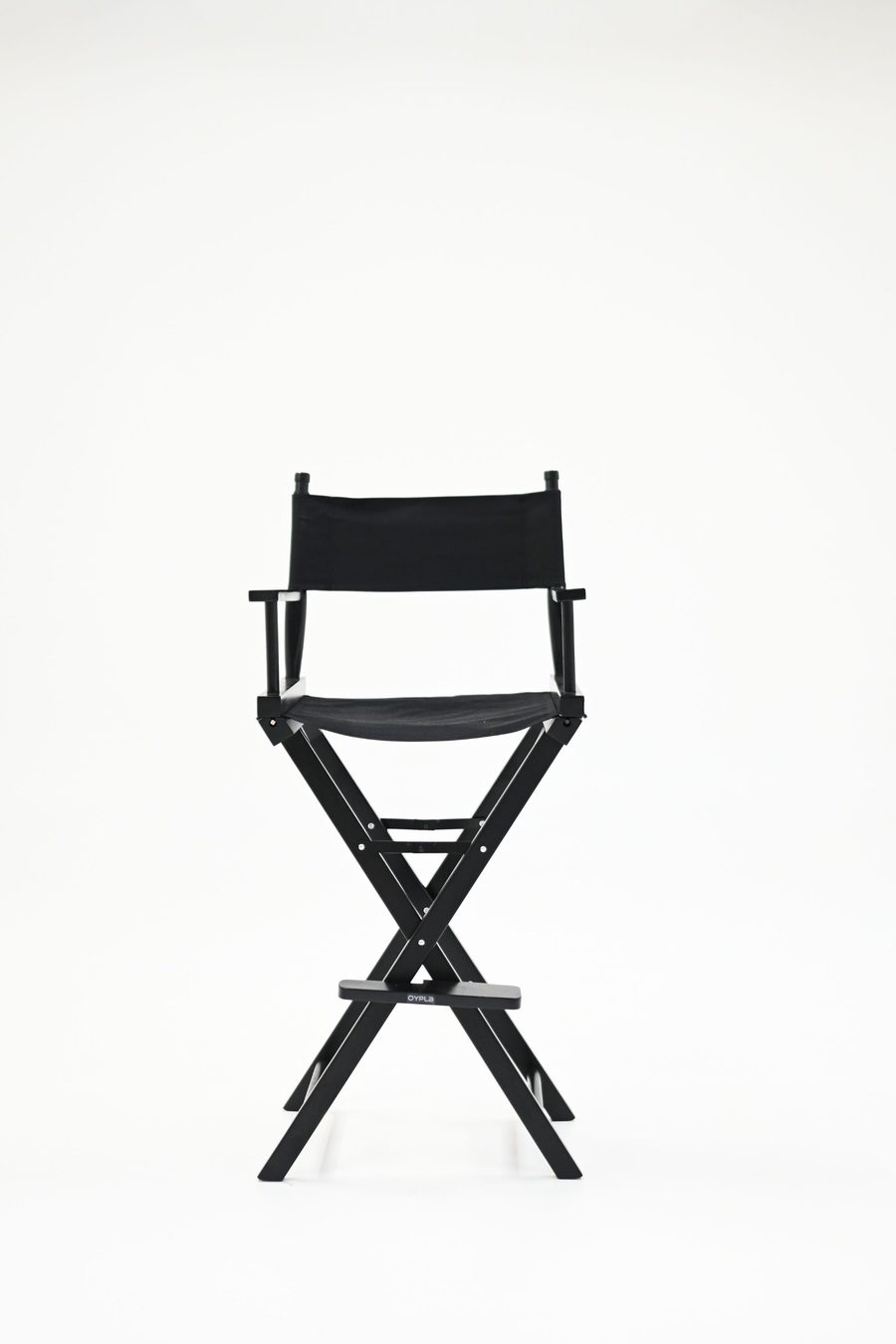 Black director's chair on the white infinity wall at the studio
