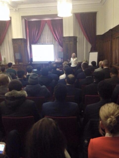 Emily Mallender speaking to a packed seminar room early in her speaking career