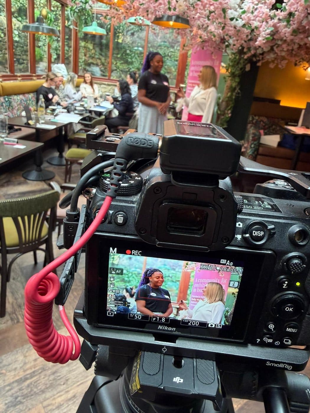 EMpowered Media filming on location at an EMpowered networking event, camera recording on a tripod
