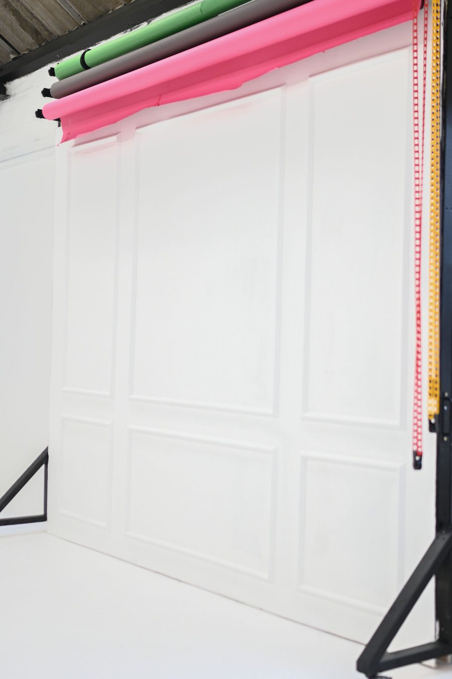 White panelled wall and colour paper backdrops at the photography studio in Creswell