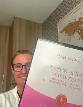 Catherine holding her Visible and Paid folder