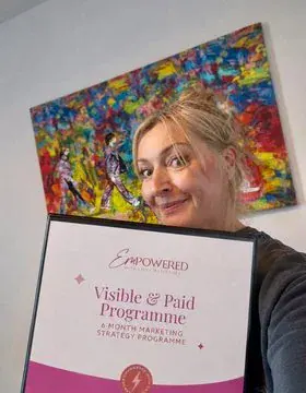 Lynn holding her Visible and Paid folder