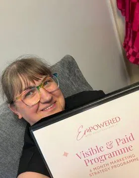 Paula holding her Visible and Paid folder